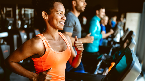 female running on treadmill in fitness center